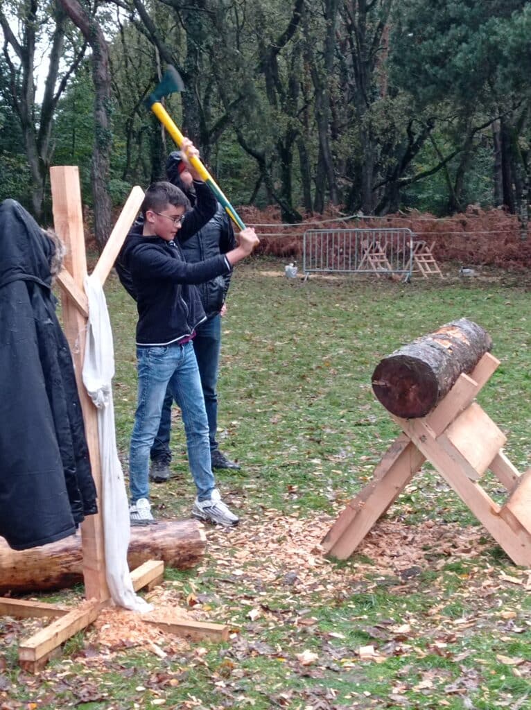 Un élève en train d'essayer de couper du bois